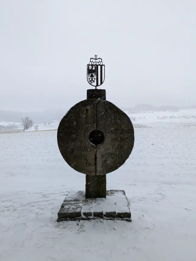 Mühlstein, der die Große Europäische Wasserscheide bei Bad Leonfelden kennzeichnet